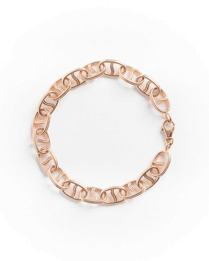 Rose gold bracelet on a white background