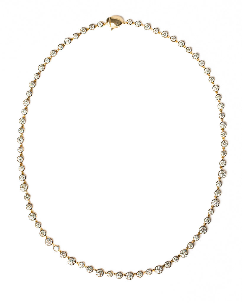 diamond and gold necklace on white background