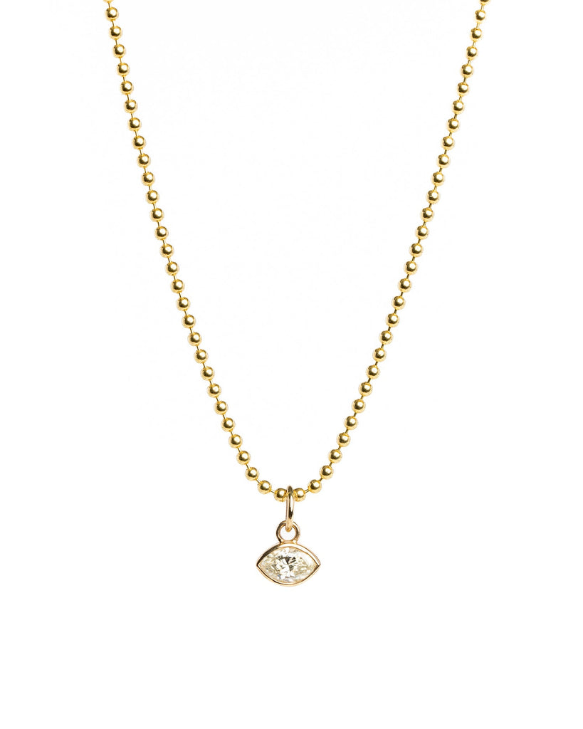 Gold necklace with a small pendant on a white background