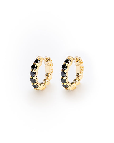 Gold hoop earrings with black stones on a white background