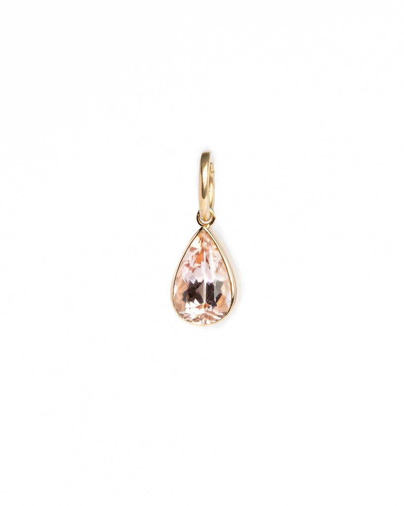 Teardrop-shaped pendant with rose gold frame on a white background